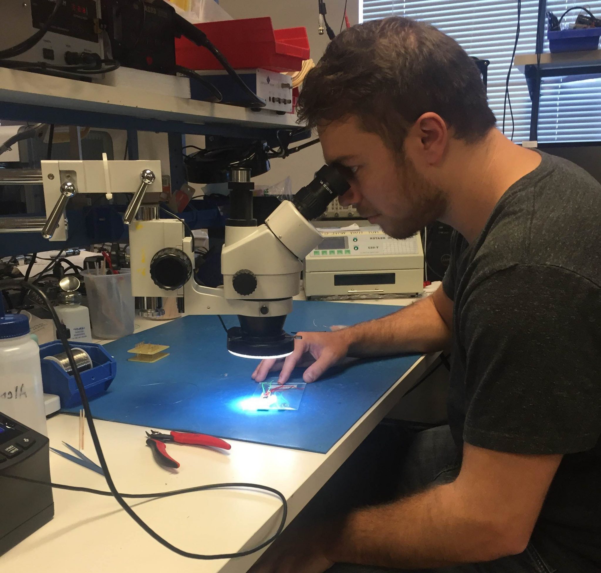 Brian examining a circuit closely